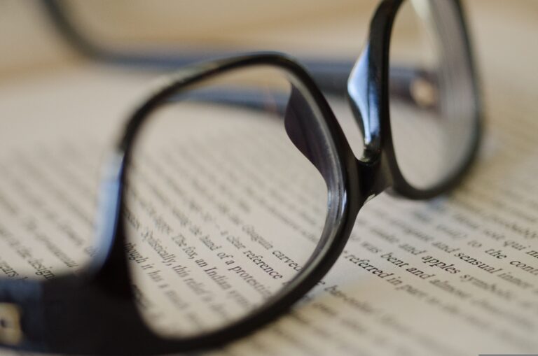 Reading glasses placed over printed text